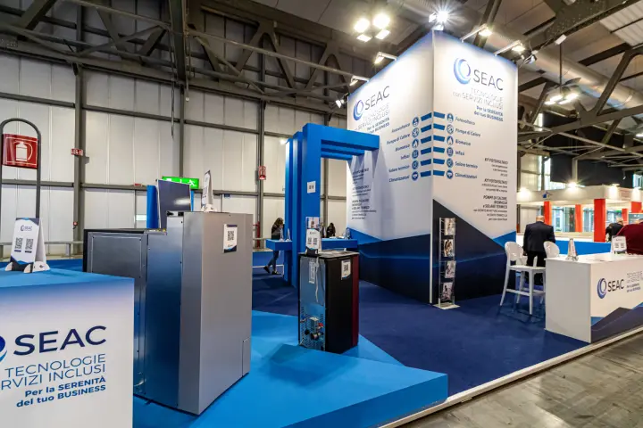 SEAC heat pump and stove on blue platforms with service list tower