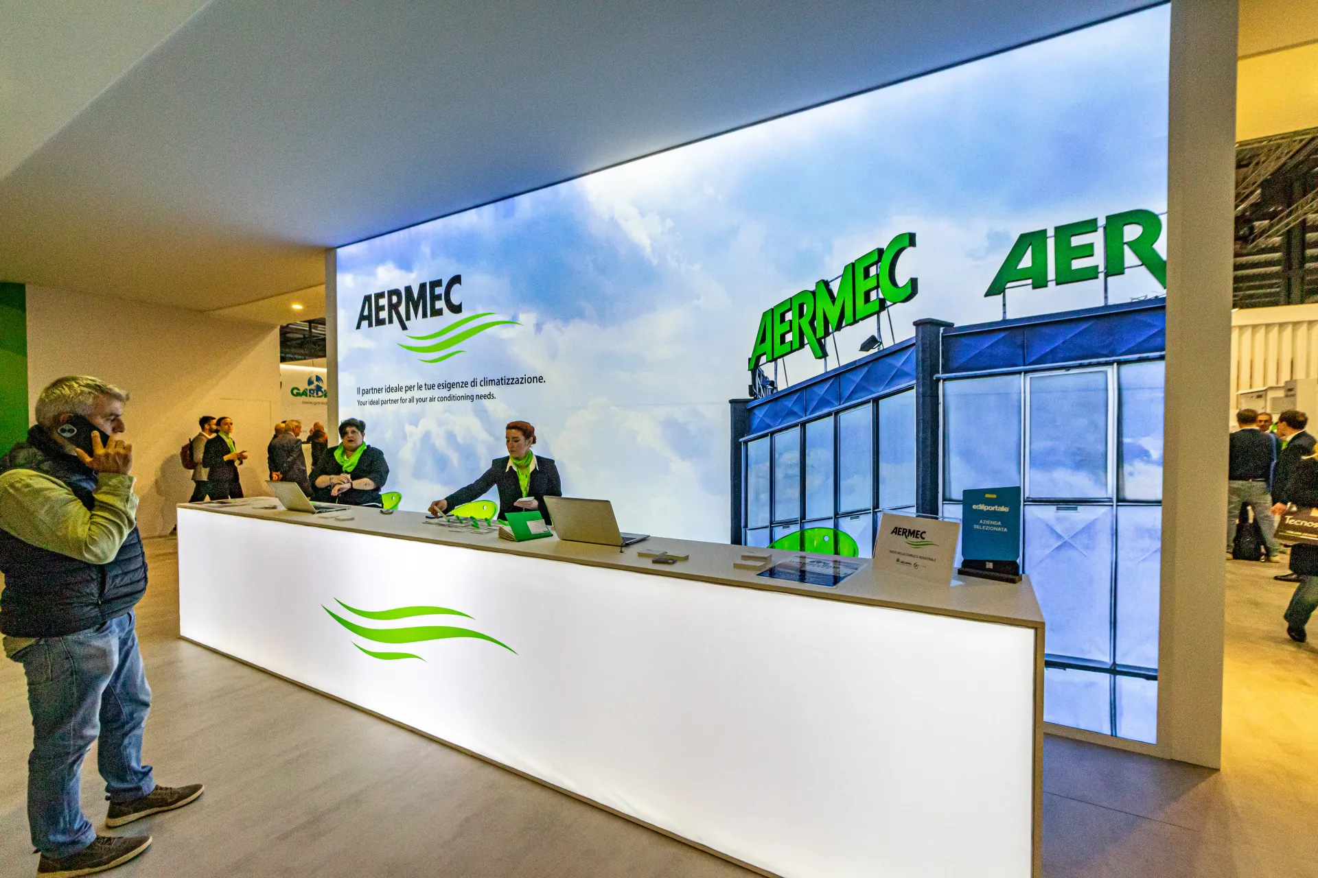 Side view of the long Aermec reception desk and lightbox wall at MCE 2024