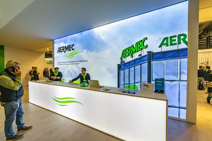 Side view of the long Aermec reception desk and lightbox wall at MCE 2024