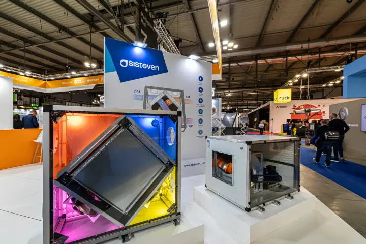 Sisteven heat recovery unit with colour-lit open chambers beside a cabinet fan at MCE 2024