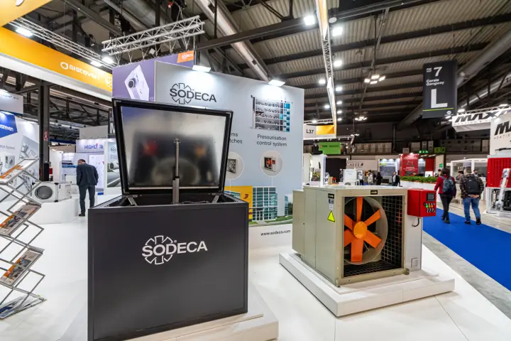 Sodeca hatch ventilation unit with raised lid next to a cased axial fan at MCE 2024