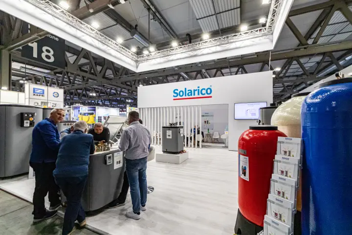 Solarico stand with storage tanks and tall red and blue vessels