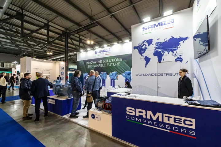 SRMTec Compressors stand with worldwide distribution map and compressor plinths at MCE 2024