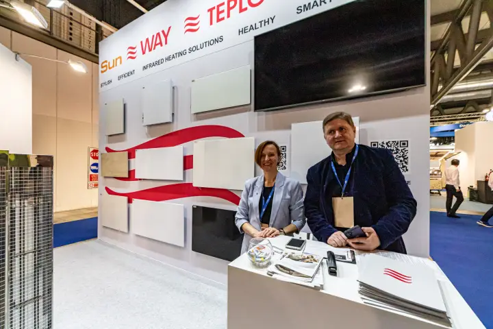 Staff at the SunWay and TeploCeramic counter in front of infrared panels at MCE 2024