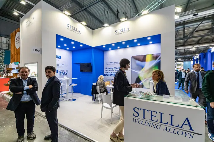 Stella Welding Alloys stand with blue-lit interior and branded counter