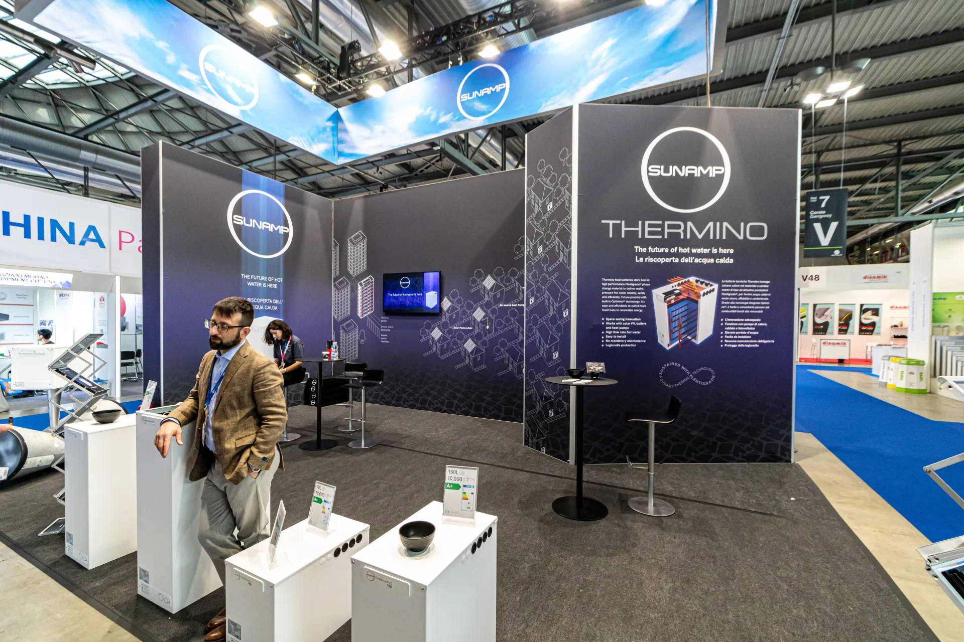 Sunamp Thermino heat batteries with energy labels before indigo walls at MCE 2024