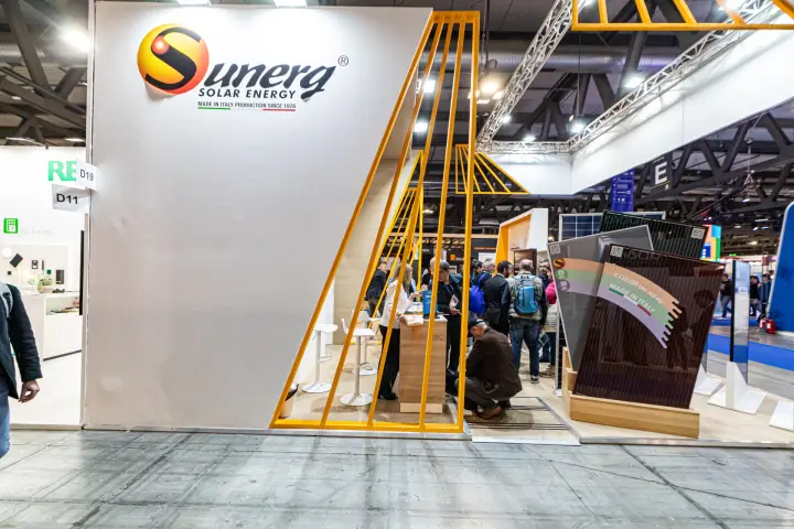 Sunerg stand entrance with yellow slatted frame and crowd inside at MCE 2024