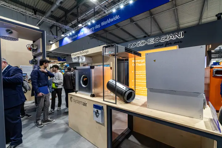 Systemair duct fan box and circular duct section on a plywood table at MCE 2024