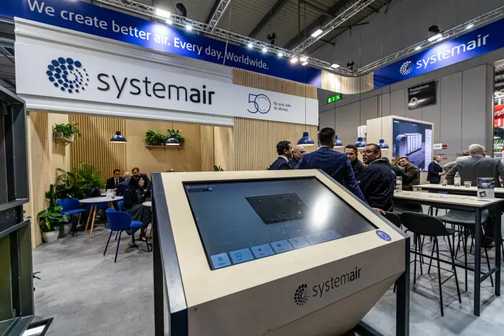 Systemair touchscreen kiosk in front of the wood-panelled meeting area at MCE 2024