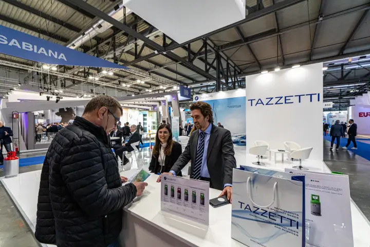 Tazzetti counter with refrigerant leaflets and branded bags at MCE 2024