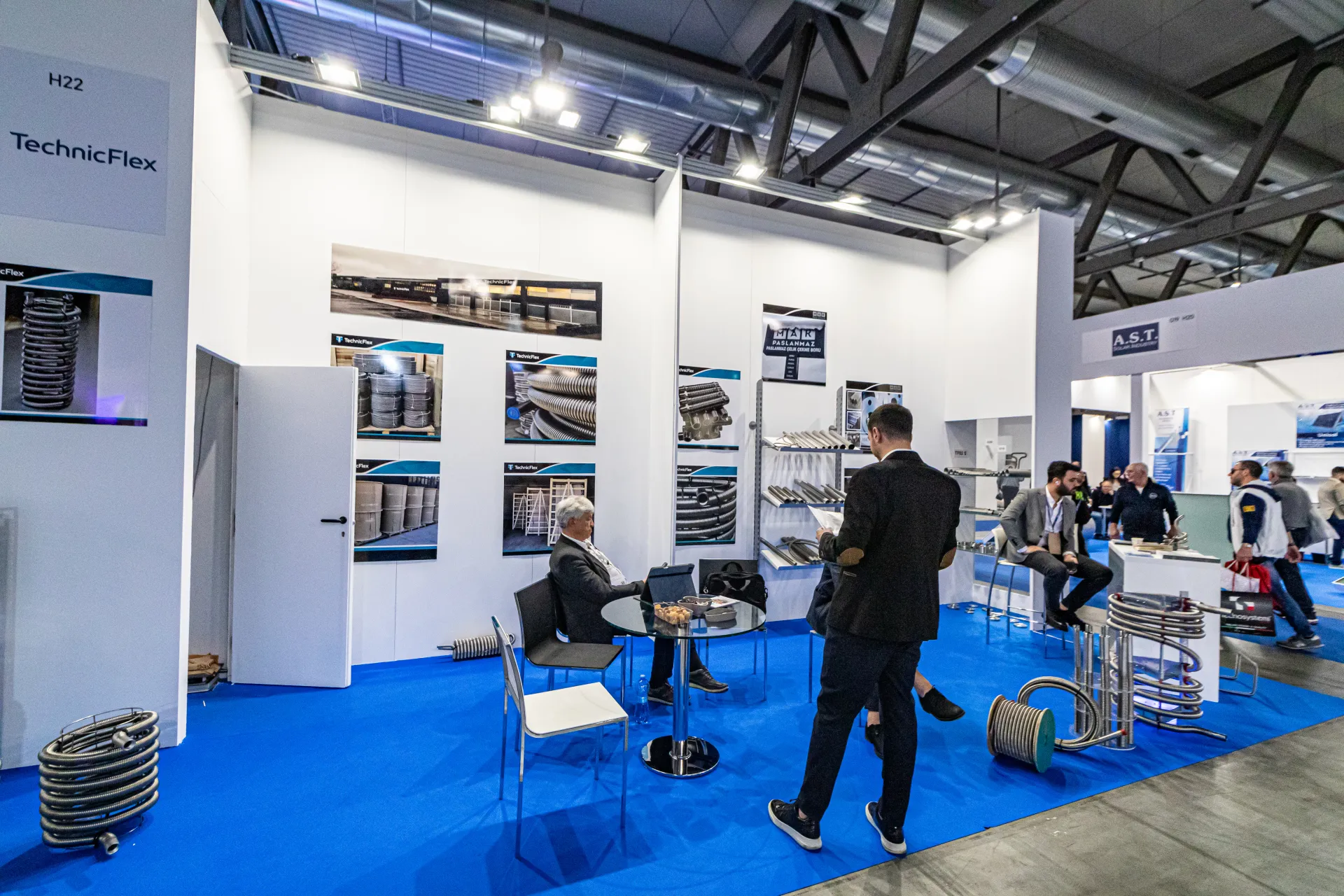 TechnicFlex booth H22 with stainless flexible pipe coils and product photos at MCE 2024