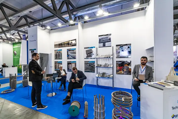 TechnicFlex corrugated stainless steel hoses and coils on a blue-carpeted stand at MCE 2024