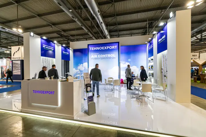 Tehnoexport stand with 'Air Control' backlit wall and meeting tables at MCE 2024