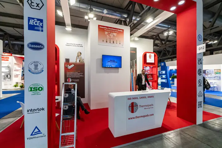 Thermopads stand front with certification columns and red portal at MCE 2024