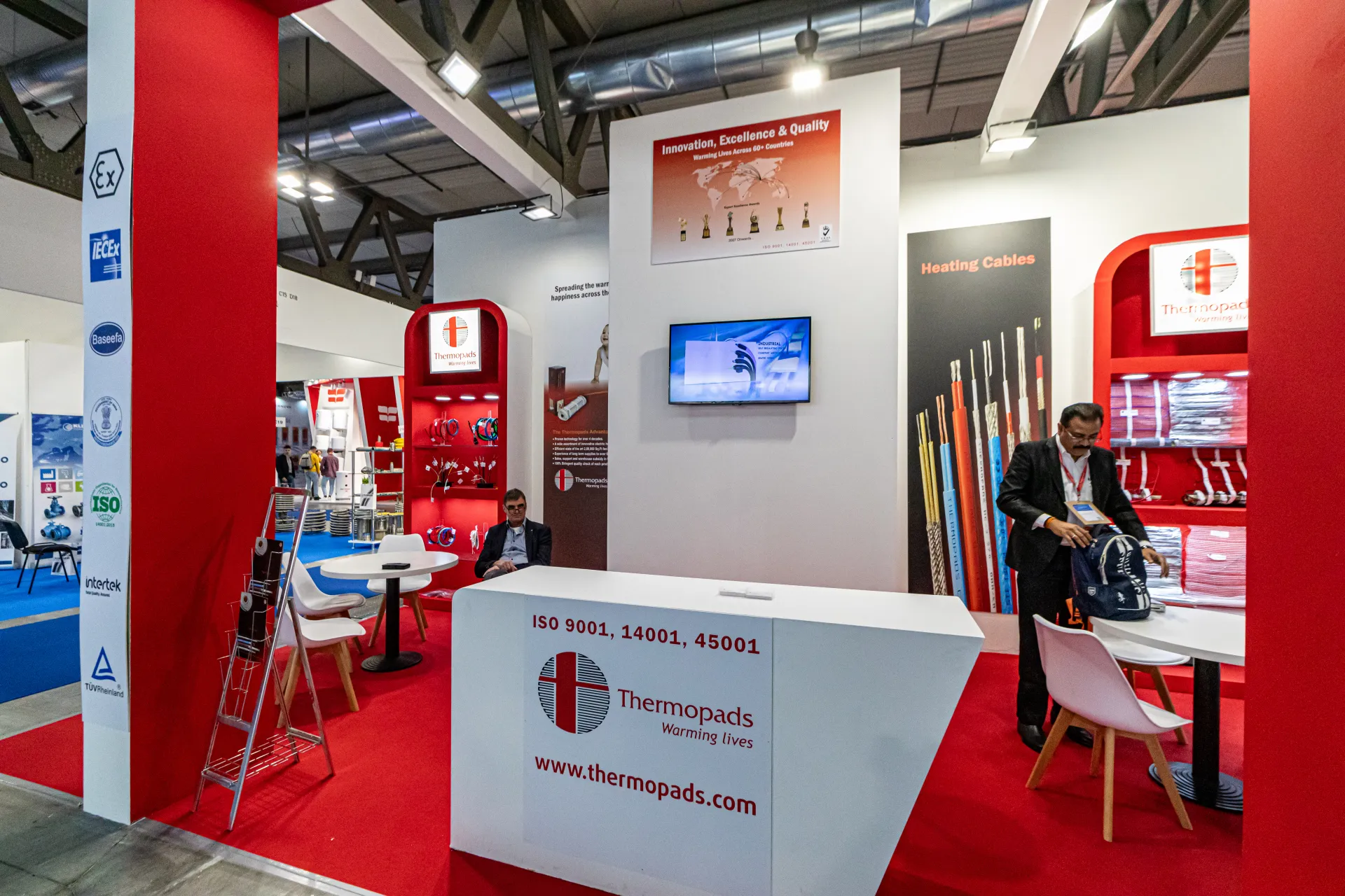 Thermopads stand with heating cables on red arched shelving at MCE 2024