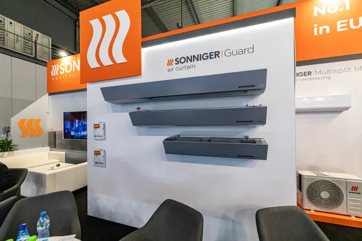 Three Sonniger Guard air curtains mounted on a white display wall