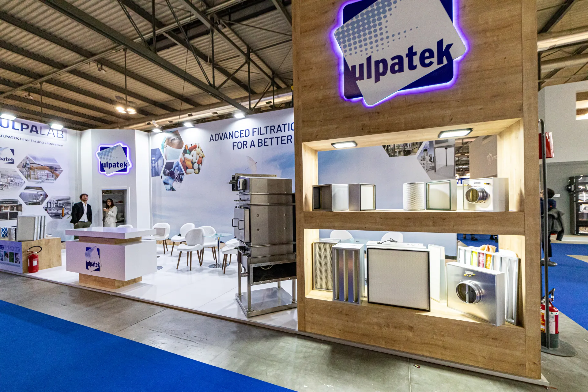 Ulpatek filter display in an oak-finish column with lit logo at MCE 2024