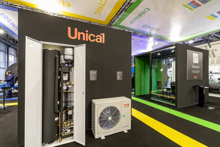 Unical indoor heat pump cabinet shown open next to an HP_QOR outdoor unit at MCE 2024