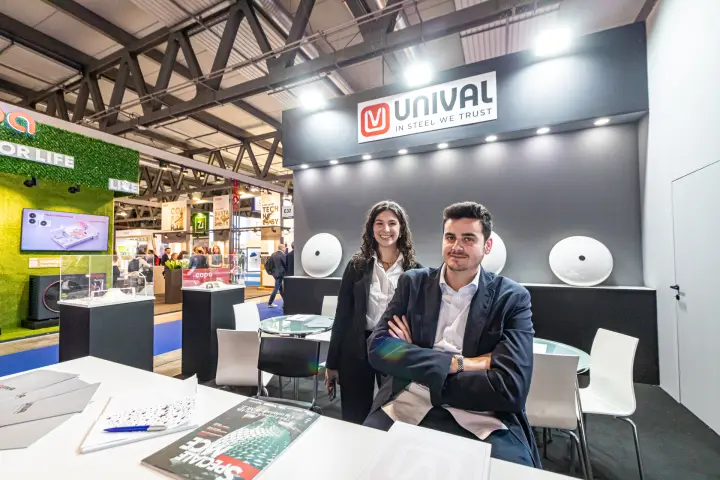 Unival desk with dished ends on the back wall and glass display cases