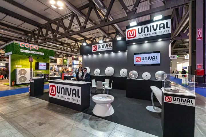 Unival stand with steel dished heads displayed on a dark wall