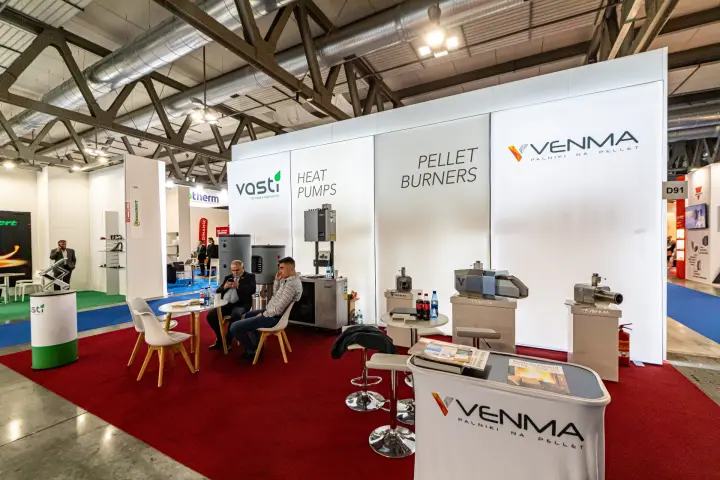 Venma pellet burners and Vasti heat pumps on a shared stand with a backlit white wall at MCE 2024