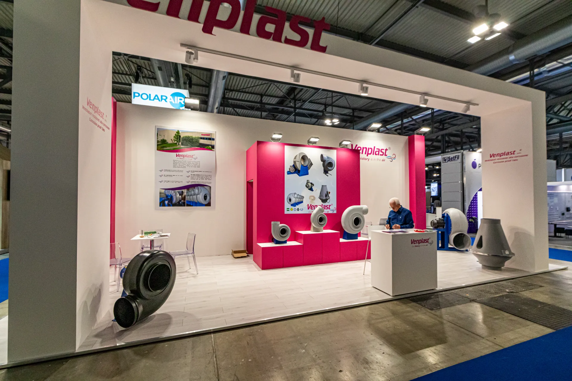 Venplast fans on magenta plinths beneath the stand's white frame at MCE 2024