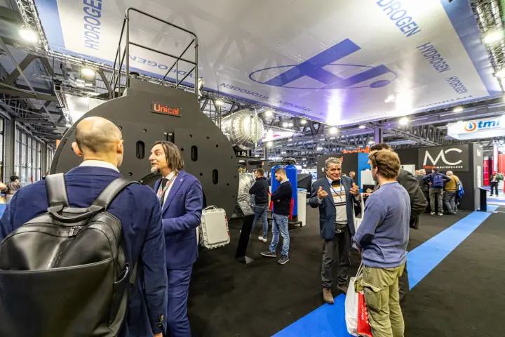Visitors around a large Unical boiler in the hydrogen area