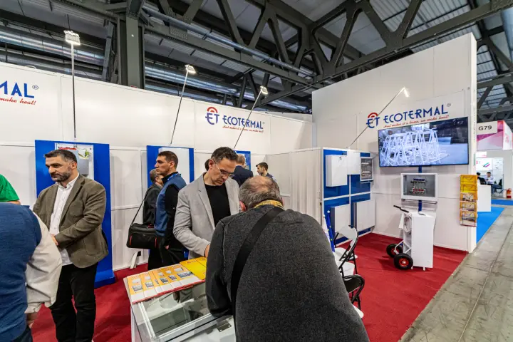 Visitors browse manifold box brochures at the Ecotermal stand at MCE 2024