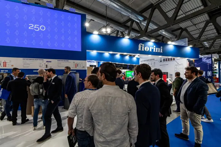 Visitors crowd the Fiorini stand beneath a large LED wall at MCE 2024