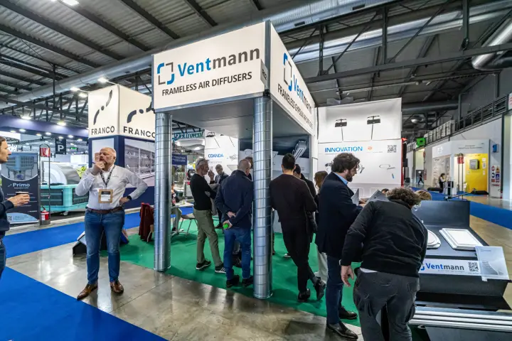 Visitors crowd the Ventmann stand of frameless air diffusers at MCE 2024