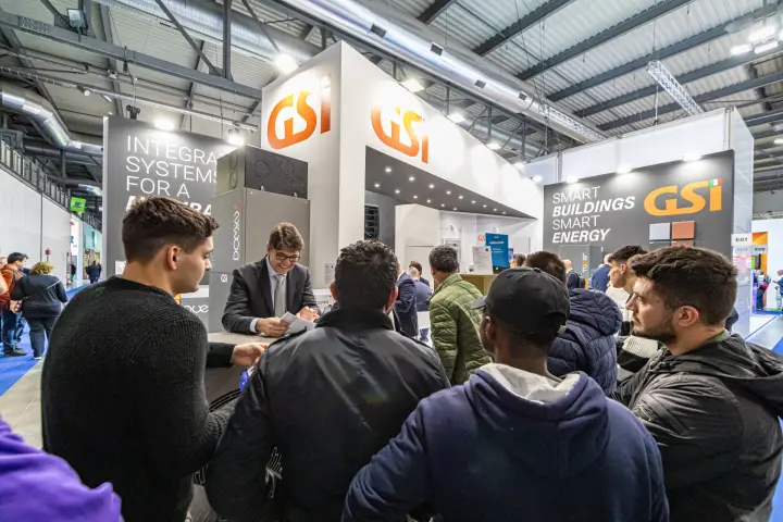 Visitors crowding the GSi front counter under orange GSi logos