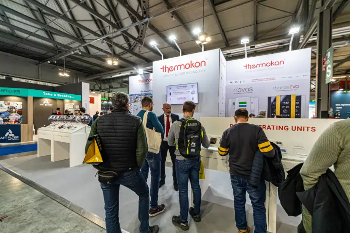 Visitors at the Thermokon room operating units counter at MCE 2024