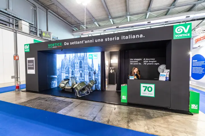 Vortice 70th anniversary stand with vintage scooter and fans at MCE 2024