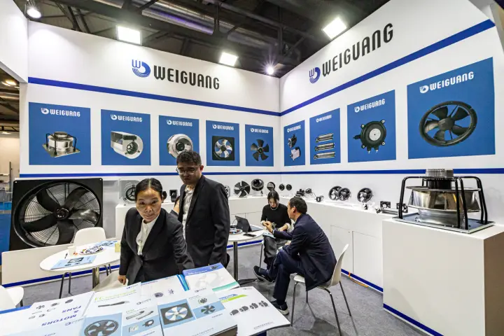 Weiguang catalogues for fans and motors in front of the fan display wall at MCE 2024
