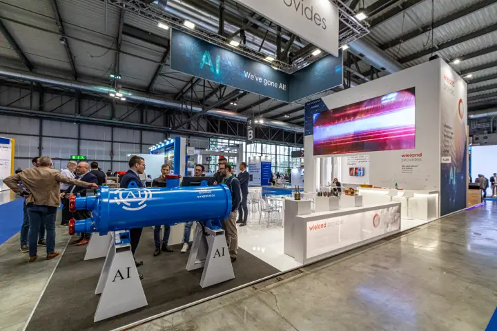 Wieland stand with blue AI assisted evaporator and hanging We've gone AI! sign