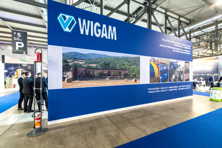 Wigam back wall with countryside building photo and 'Since 1978' slogan at MCE 2024