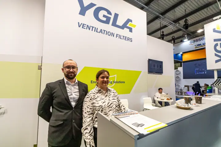 YGLA staff at the stand counter beneath the Ventilation Filters logo