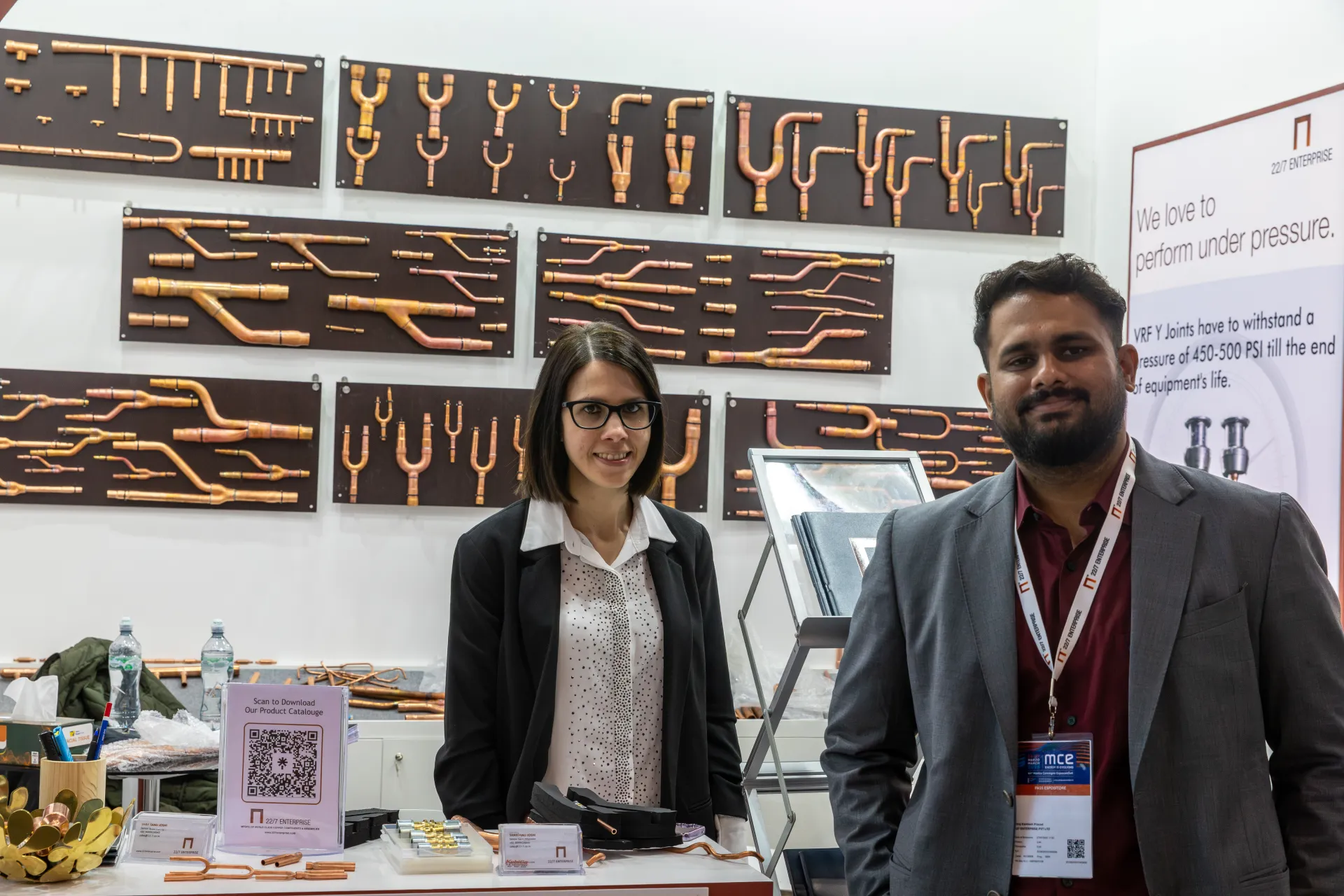 22/7 Enterprise team in front of copper VRF Y-joint display boards at MCE 2026