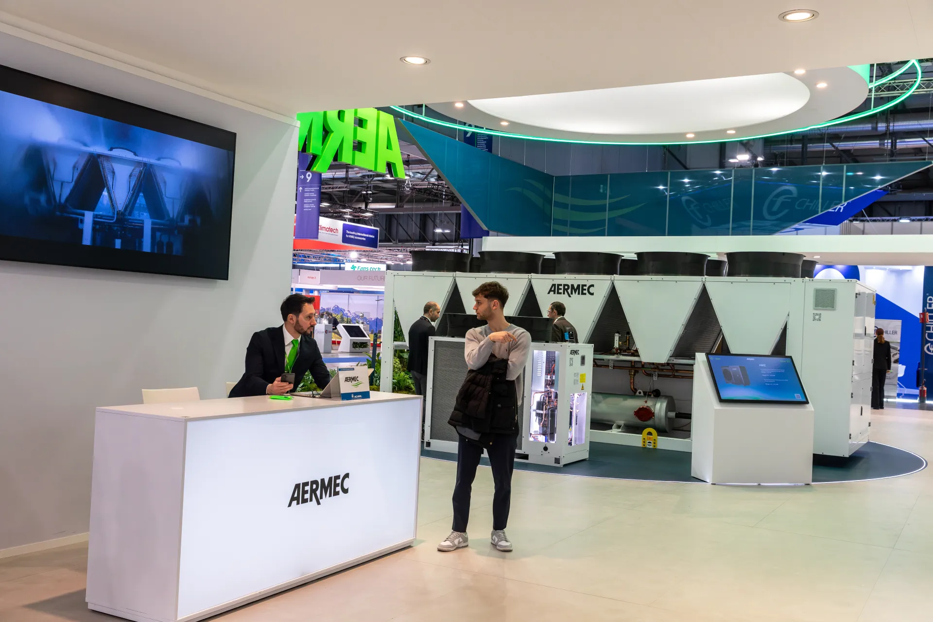 Aermec stand with large air-cooled chiller and reception desk at MCE 2026