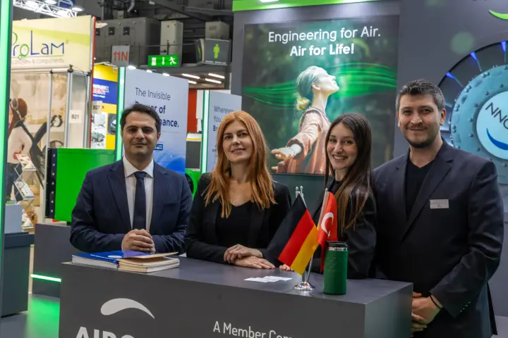 Aironn team at the counter under the 'Air for Life!' graphic at MCE 2026