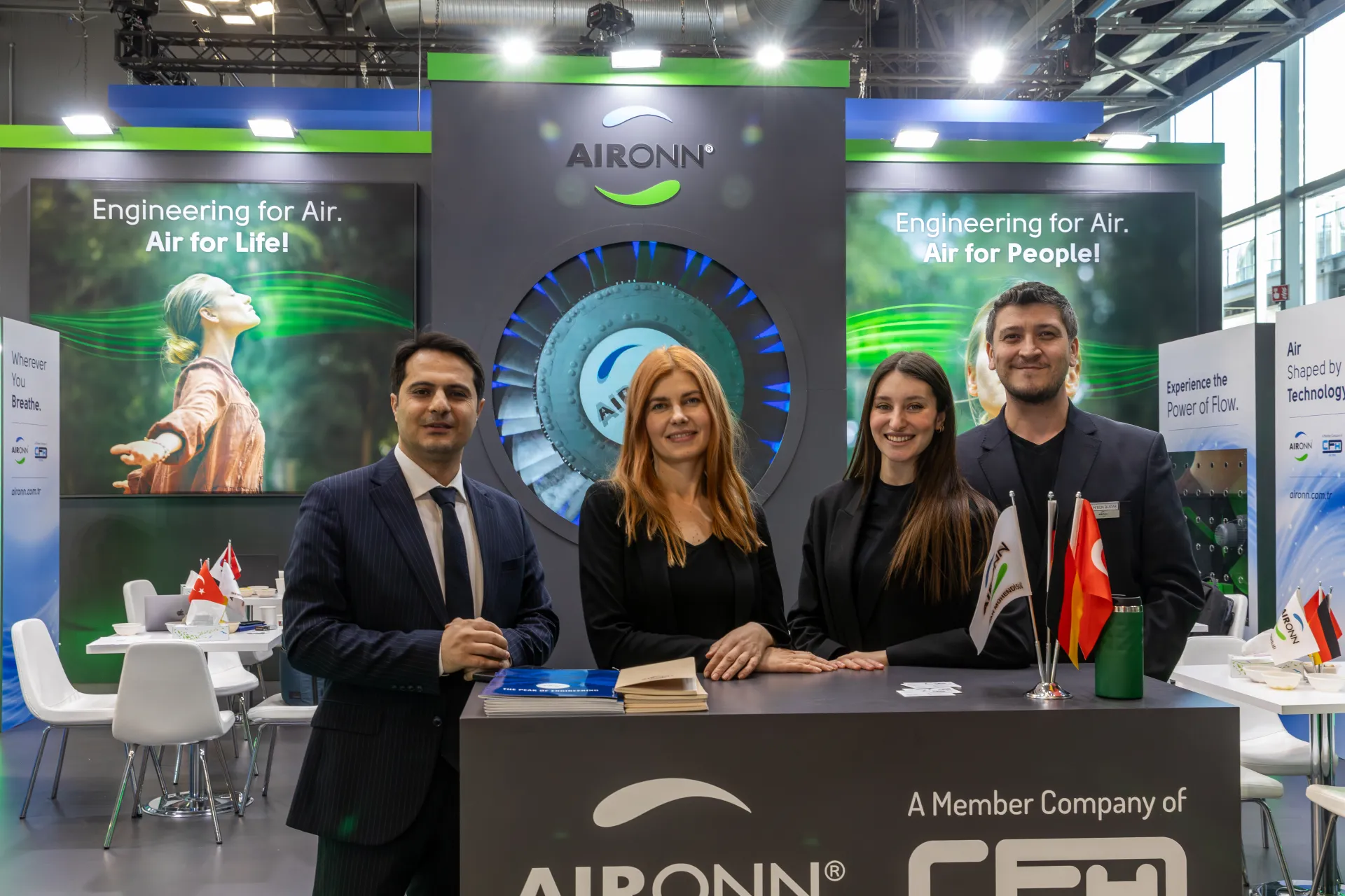 Aironn team at the reception counter in front of a backlit fan impeller at MCE 2026