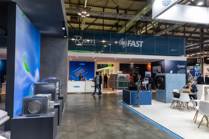 Aisle view with Aspirnova box fans and the Fast, Rpm and Sierra stand at MCE 2026
