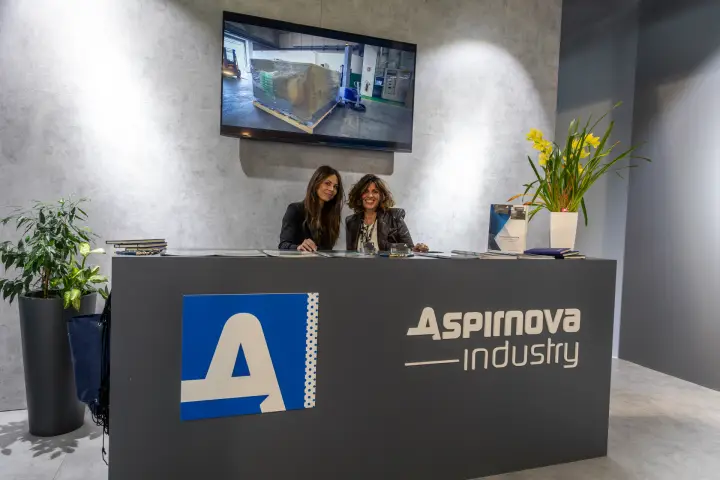 Aspirnova Industry reception desk with catalogues and video screen at MCE 2026