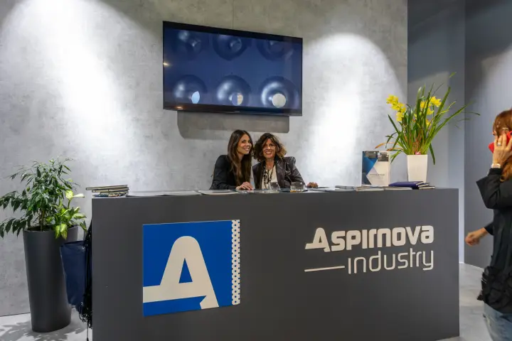 Aspirnova Industry reception desk with fan video on screen at MCE 2026