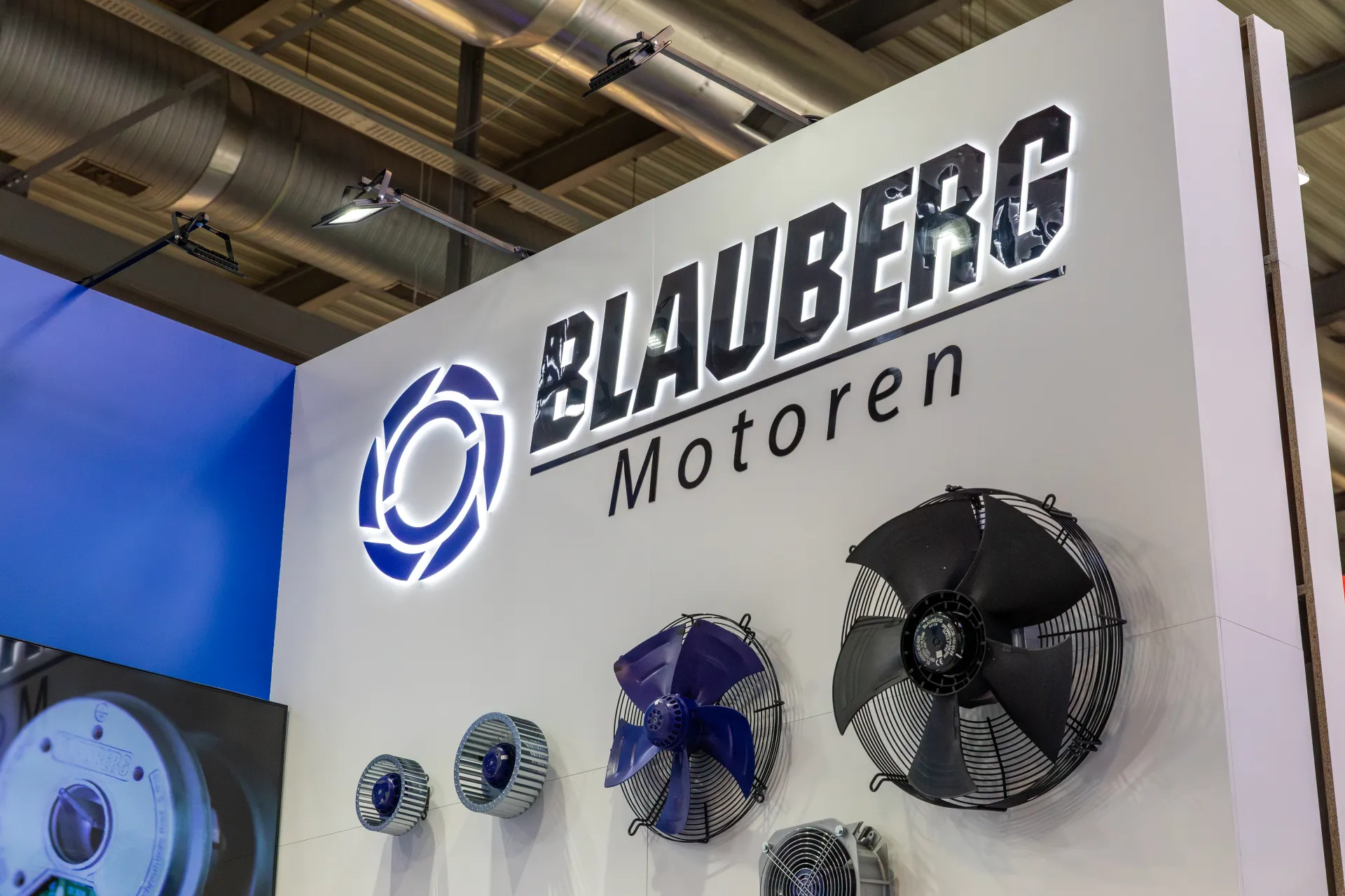Backlit Blauberg Motoren logo above axial and centrifugal fans at MCE 2026