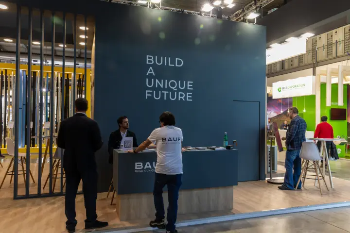 BAUF reception counter in front of a 'Build a Unique Future' wall at MCE 2026