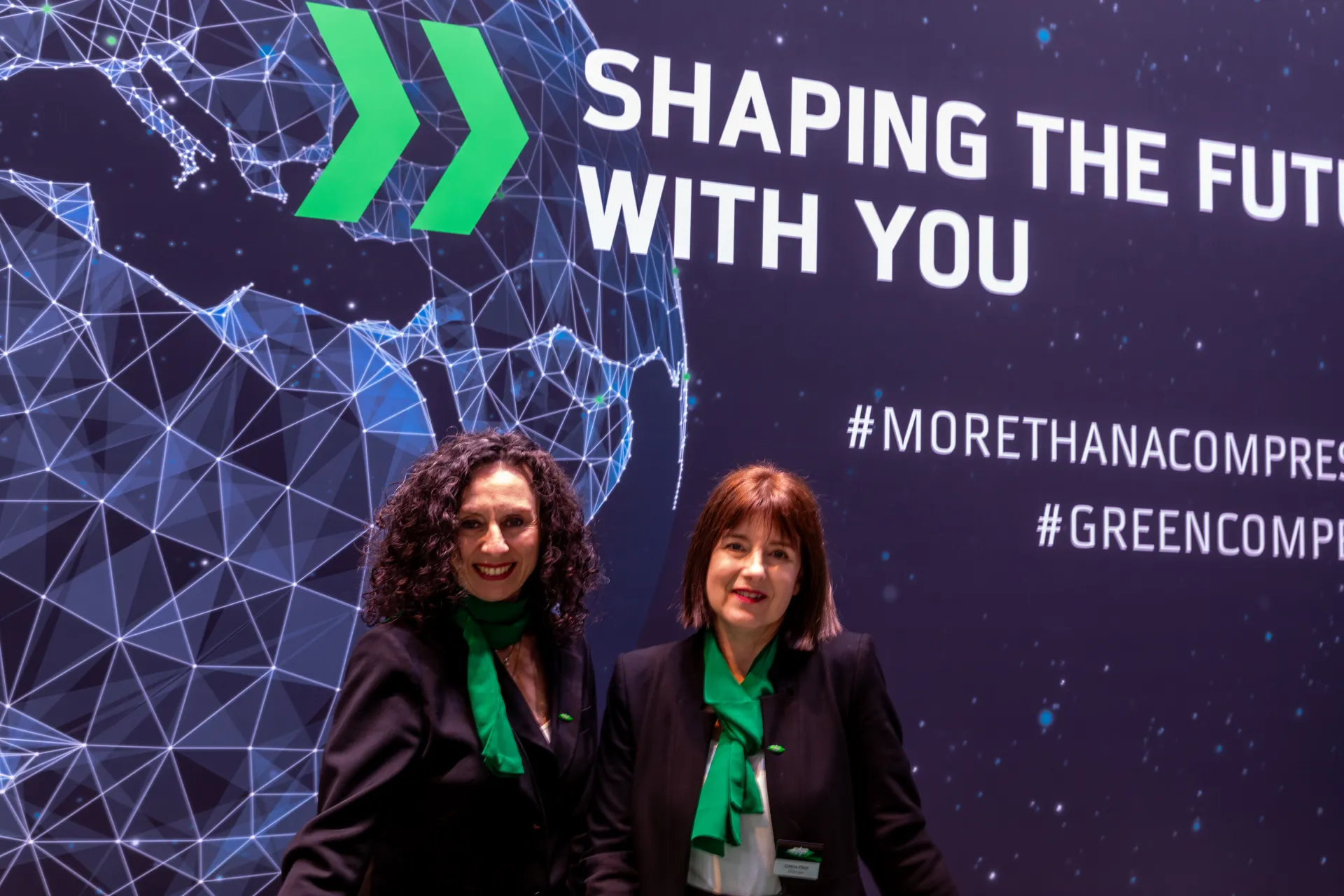 Bitzer slogan wall with staff, tighter crop of the reception area at MCE 2026