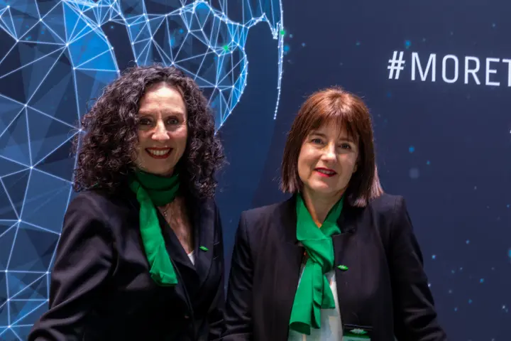 Bitzer staff portrait in front of the network globe backdrop at MCE 2026