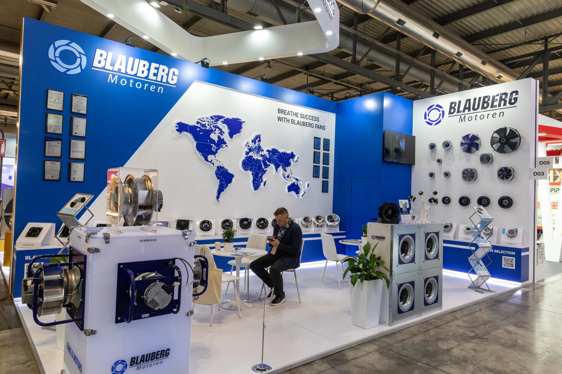 Blauberg Motoren stand with fan wall and "Breathe success" world map at MCE 2026