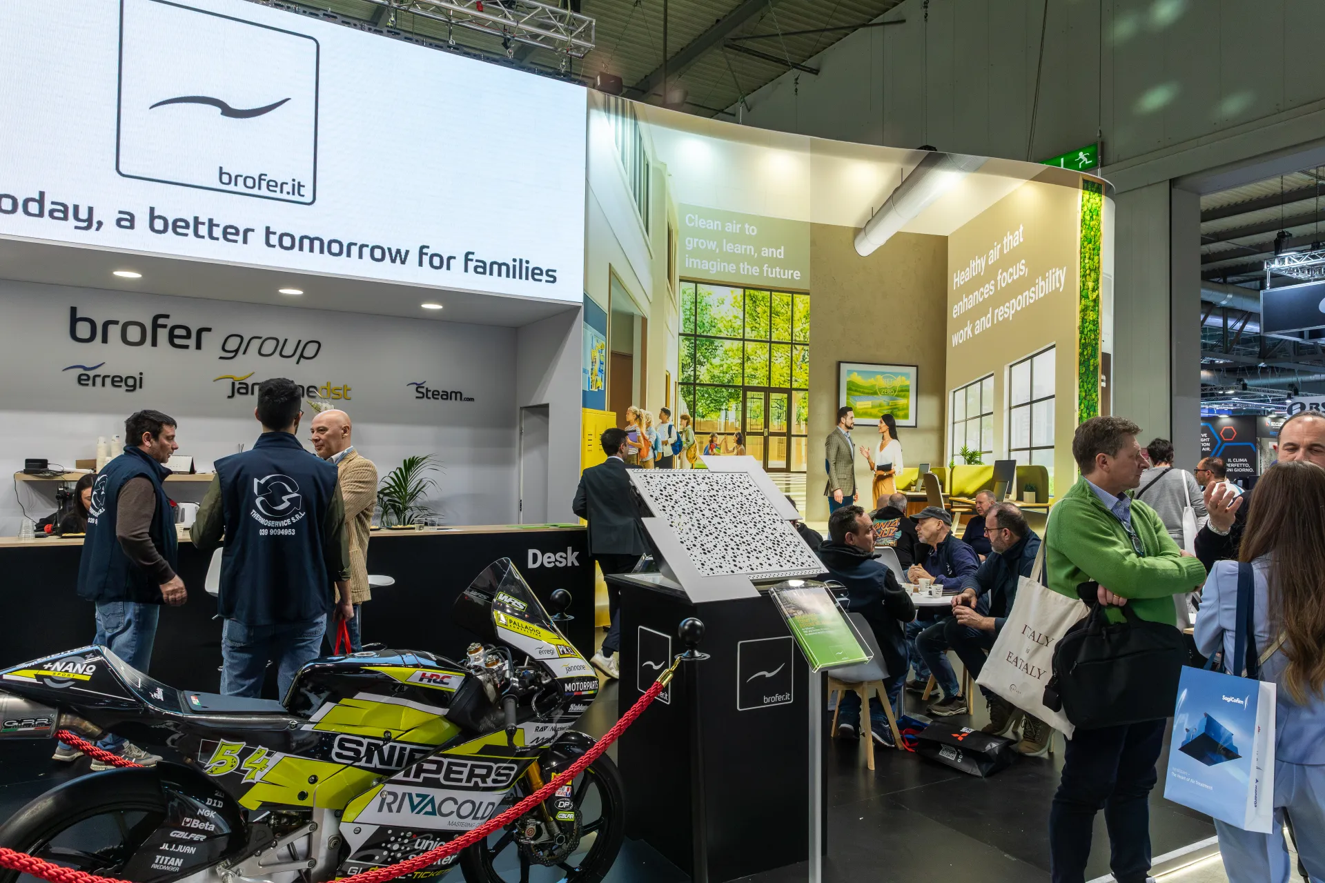 Brofer group desk with Erregi and Steam logos and a racing motorcycle at MCE 2026